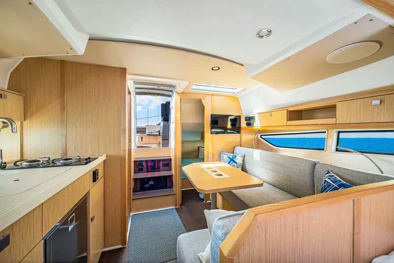  Yacht Photos Pics 2019 Sealine S330V yacht interior with modern kitchen, dining area, and panoramic windows.