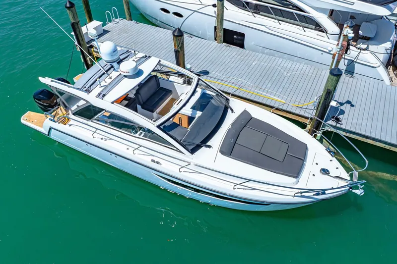  Yacht Photos Pics 2019 Sealine S330V yacht docked in turquoise water, featuring sleek design and spacious deck.