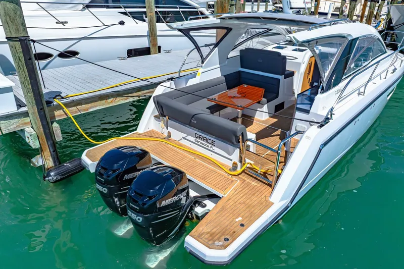  Yacht Photos Pics 2019 Sealine S330V yacht docked, featuring twin Mercury outboard engines and a spacious deck.