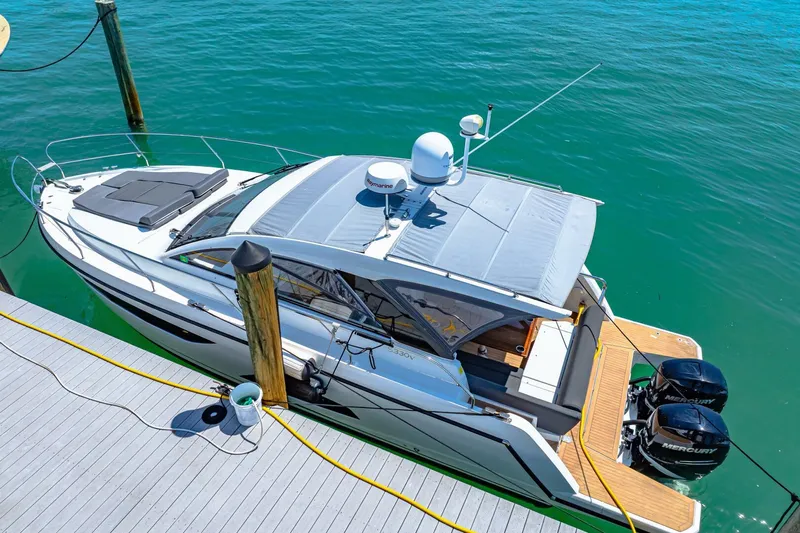  Yacht Photos Pics 2019 Sealine S330V yacht docked, featuring sleek design and twin outboard engines.