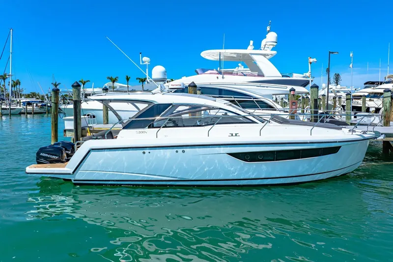  Yacht Photos Pics 2019 Sealine S330V yacht docked in a marina under clear blue skies.