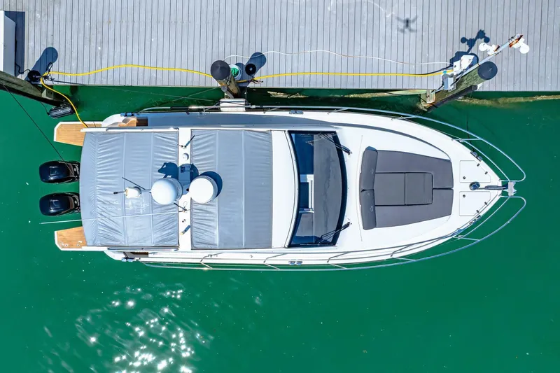  Yacht Photos Pics Aerial view of 2019 Sealine S330V yacht docked on turquoise water.
