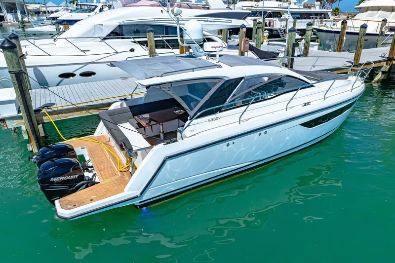 Yacht Photos Pics 2019 Sealine S330V yacht docked, featuring sleek design and twin Mercury outboard engines.