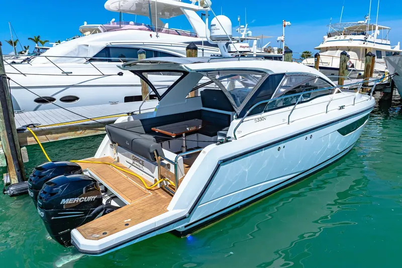  Yacht Photos Pics 2019 Sealine S330V yacht docked, featuring sleek design and twin Mercury outboard engines.