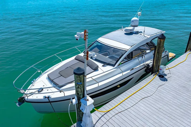  Yacht Photos Pics 2019 Sealine S330V yacht docked at a marina with clear blue water.