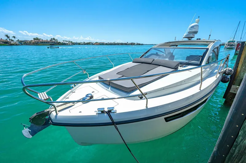  Yacht Photos Pics 2019 Sealine S330V yacht docked in clear turquoise water under a bright blue sky.