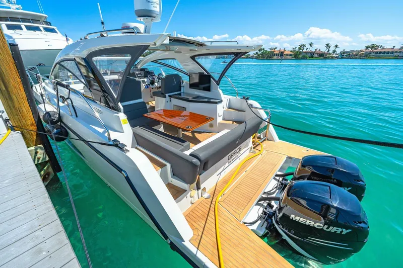  Yacht Photos Pics 2019 Sealine S330V yacht docked, featuring open deck and twin Mercury outboard engines.