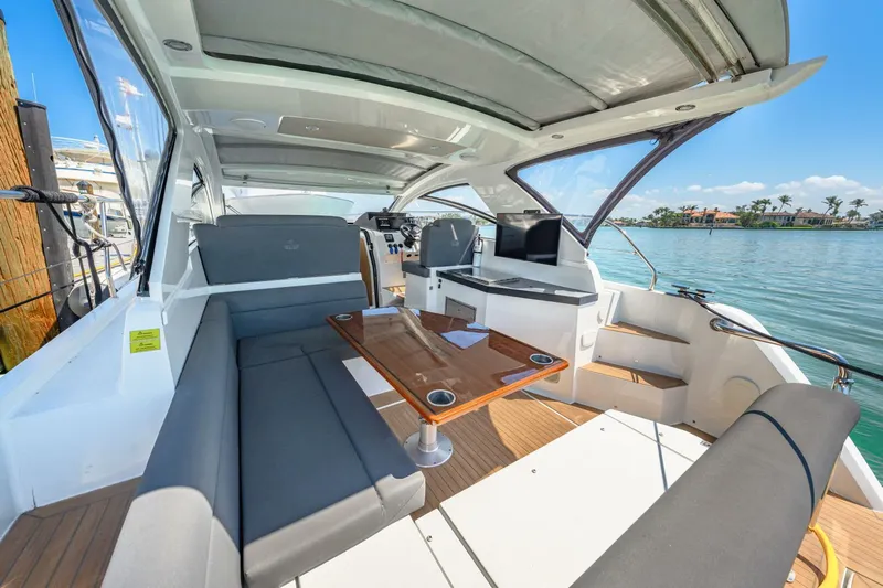  Yacht Photos Pics 2019 Sealine S330V yacht interior with spacious seating and table, overlooking serene water views.