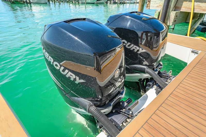  Yacht Photos Pics Twin Mercury outboard engines on a 2019 Sealine S330V boat, docked in clear turquoise water.