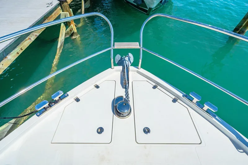  Yacht Photos Pics Bow of 2019 Sealine S330V yacht with anchor, docked in turquoise water.