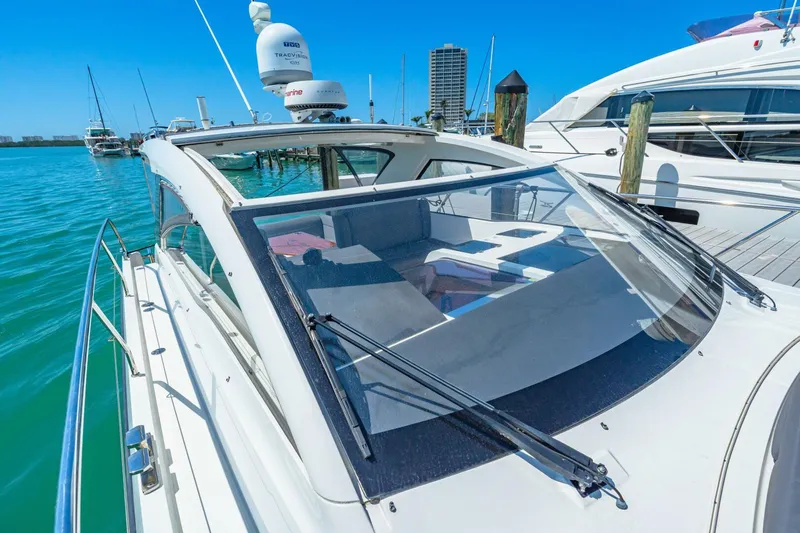  Yacht Photos Pics 2019 Sealine S330V yacht docked in a marina, featuring sleek design and clear blue waters.