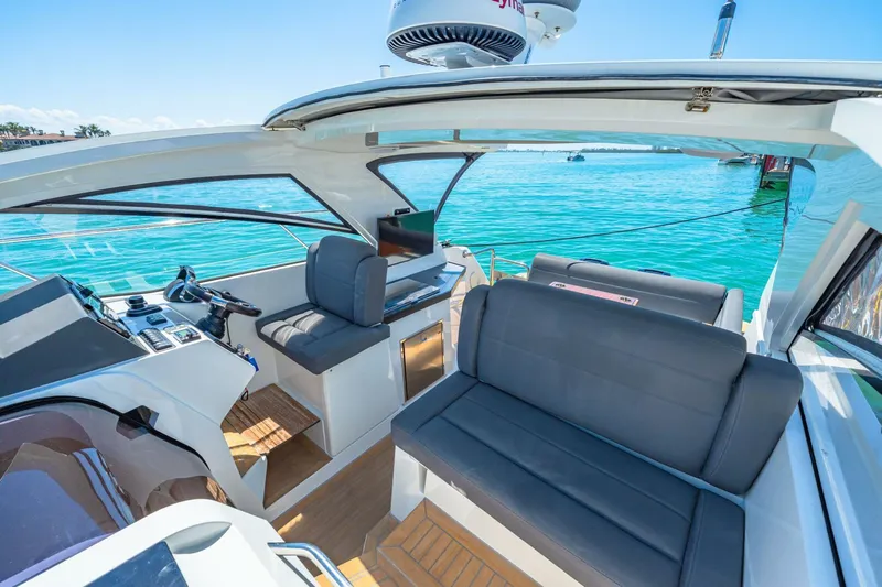  Yacht Photos Pics 2019 Sealine S330V yacht interior with sleek seating and modern controls on clear blue water.