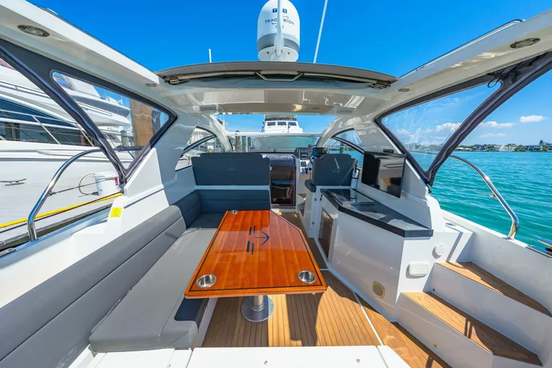  Yacht Photos Pics 2019 Sealine S330V yacht interior with sleek design, wooden table, and modern amenities.
