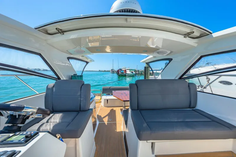  Yacht Photos Pics 2019 Sealine S330V yacht interior with seating, open roof, and ocean view.