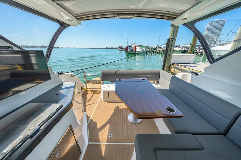  Yacht Photos Pics 2019 Sealine S330V yacht interior with seating, table, and waterfront view.