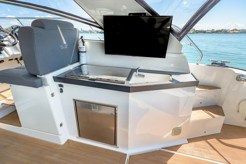  Yacht Photos Pics 2019 Sealine S330V yacht interior with kitchenette, seating, and water views.