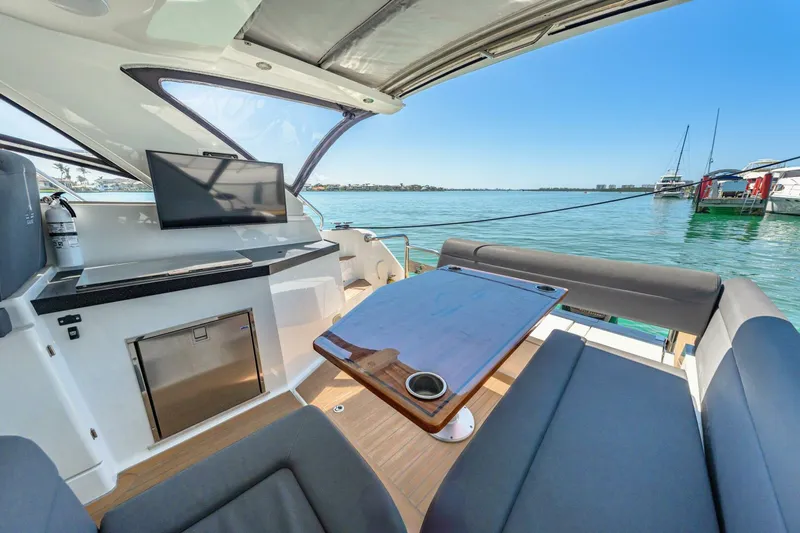  Yacht Photos Pics 2019 Sealine S330V yacht interior with seating, table, and water view.