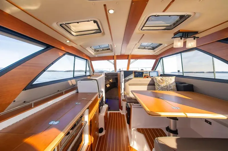  Yacht Photos Pics Interior of 2023 Cutwater C-32 Coupe boat, featuring elegant wood finishes and modern design.