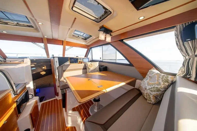  Yacht Photos Pics 2023 Cutwater C-32 Coupe interior with elegant wood finish and spacious seating area.