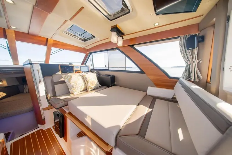  Yacht Photos Pics 2023 Cutwater C-32 Coupe interior with modern seating and panoramic windows.