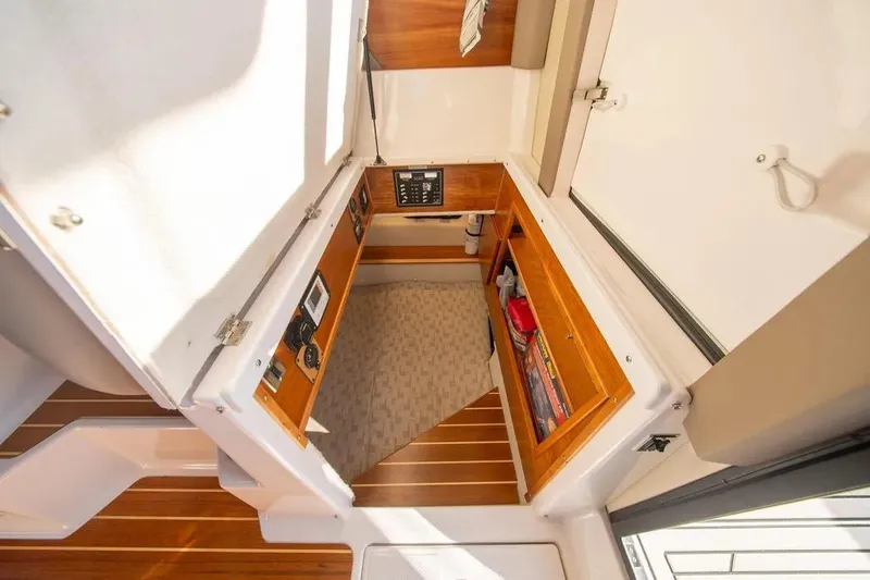 Yacht Photos Pics 2023 Cutwater C-32 Coupe interior cabin with wood accents and control panel.