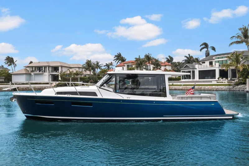 Annabelle IV Yacht Photos Pics 2024 MJM 42 yacht cruising in a scenic waterfront setting.