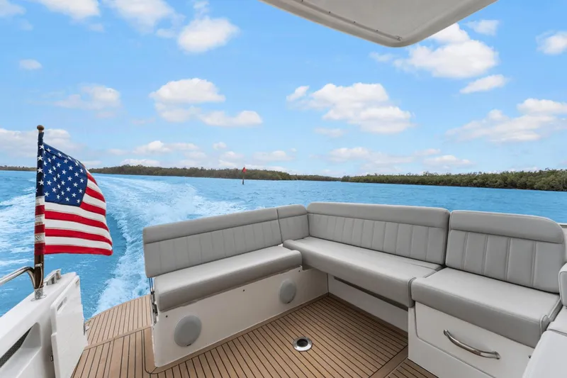 Annabelle IV Yacht Photos Pics 2024 MJM 42 yacht with American flag, cruising on blue waters under a clear sky.