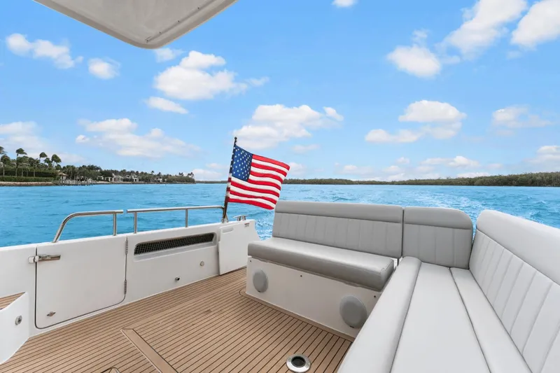 Annabelle IV Yacht Photos Pics 2024 MJM 42 yacht deck with American flag, cruising on blue waters under a clear sky.