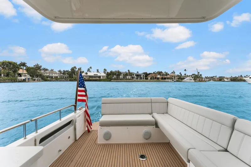 Annabelle IV Yacht Photos Pics Luxury MJM 42 yacht deck with seating, American flag, and scenic waterfront view.