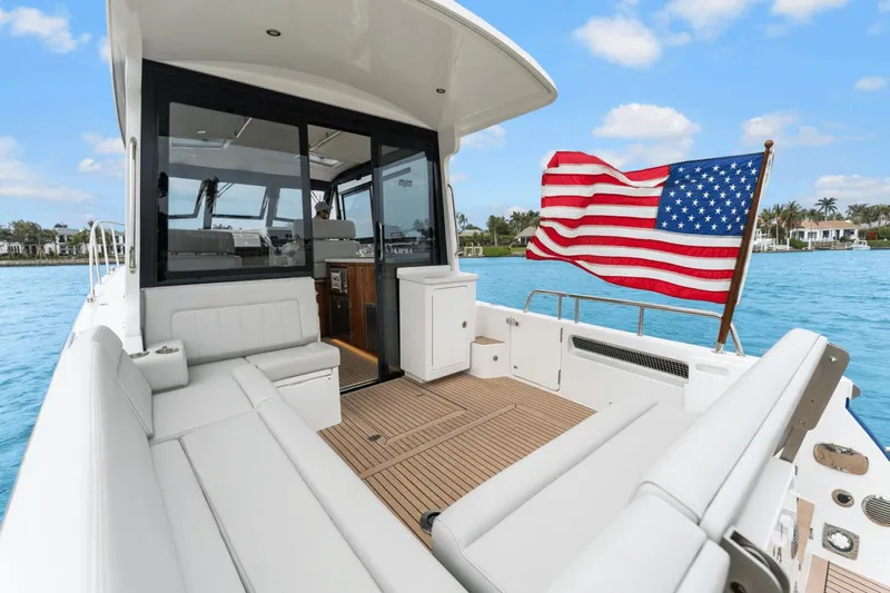 Annabelle IV Yacht Photos Pics 2024 MJM 42 yacht with American flag, spacious deck, and luxurious seating.