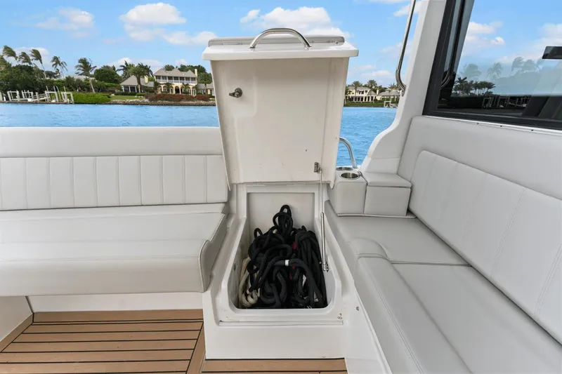 Annabelle IV Yacht Photos Pics 2024 MJM 42 boat with open storage compartment, white seating, and scenic waterfront view.