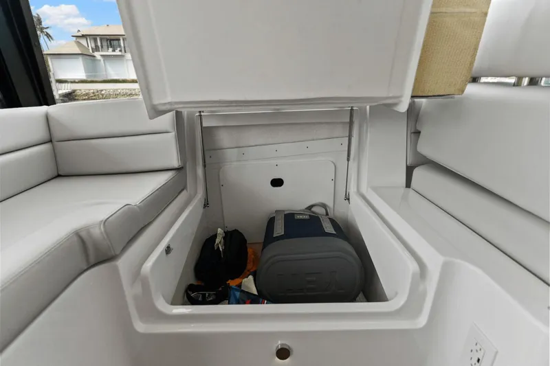 Annabelle IV Yacht Photos Pics 2024 MJM 42 boat storage compartment with cooler and bags, featuring white cushioned seating.
