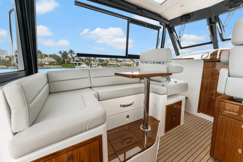 Annabelle IV Yacht Photos Pics Luxurious interior of 2024 MJM 42 yacht with elegant seating and wooden accents.