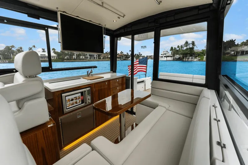 Annabelle IV Yacht Photos Pics Luxurious interior of 2024 MJM 42 yacht with elegant seating and scenic water view.