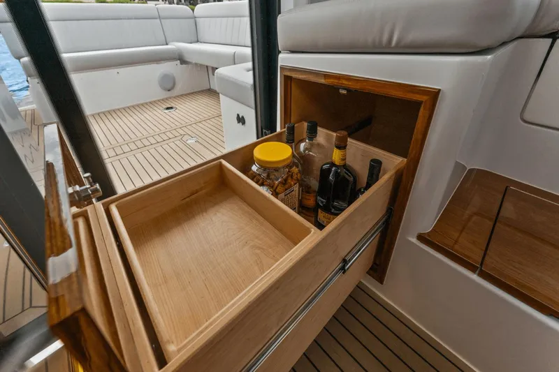 Annabelle IV Yacht Photos Pics Luxury interior of 2024 MJM 42 yacht with wooden storage drawer and seating area.