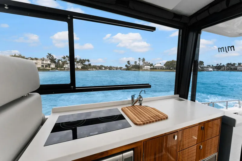 Annabelle IV Yacht Photos Pics Modern kitchen on 2024 MJM 42 yacht with ocean view through large windows.