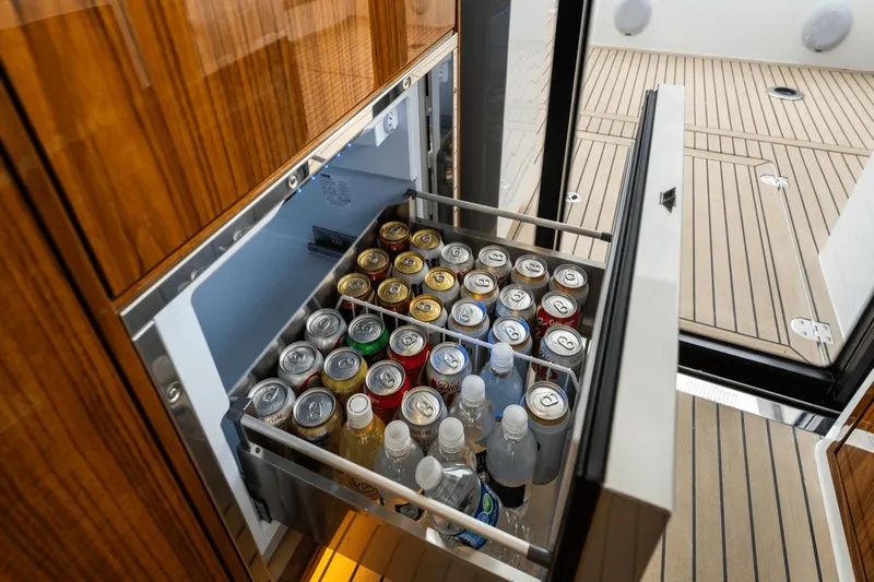 Annabelle IV Yacht Photos Pics Open beverage drawer on 2024 MJM 42 yacht, stocked with assorted drinks.