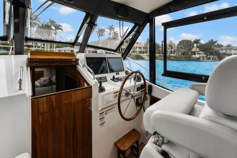 Annabelle IV Yacht Photos Pics 2024 MJM 42 yacht interior with steering wheel, navigation screens, and luxurious seating.