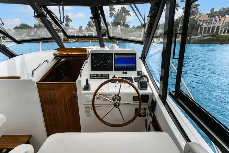Annabelle IV Yacht Photos Pics 2024 MJM 42 yacht cockpit with modern navigation equipment and wooden steering wheel.