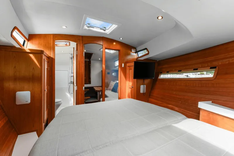 Annabelle IV Yacht Photos Pics Luxurious 2024 MJM 42 yacht interior with wood paneling, bed, and modern amenities.
