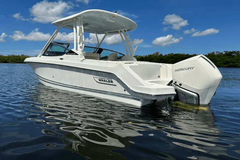 Yacht Photos Pics 2023 Boston Whaler 240 Vantage boat on calm water under blue sky.