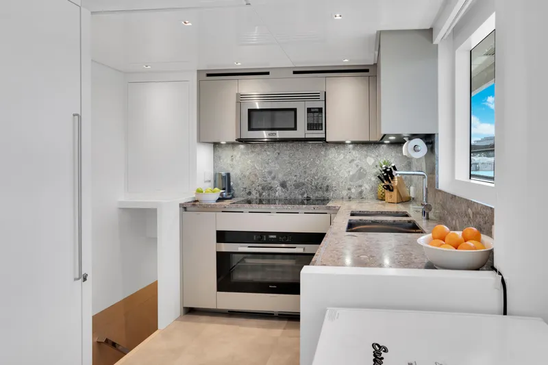 Sweet Virginia Yacht Photos Pics Modern kitchen in 2023 Sanlorenzo SL96A yacht with sleek appliances and marble countertops.
