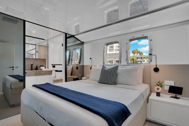 Sweet Virginia Yacht Photos Pics Luxurious 2023 Sanlorenzo SL96A yacht bedroom with modern design and scenic window view.