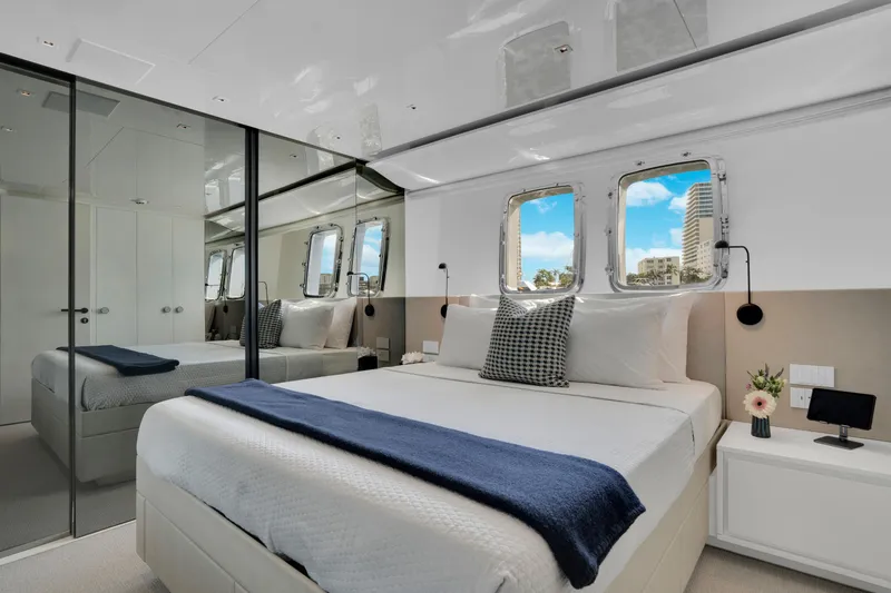 Sweet Virginia Yacht Photos Pics Luxurious bedroom interior of 2023 Sanlorenzo SL96A yacht with modern decor and ocean view.