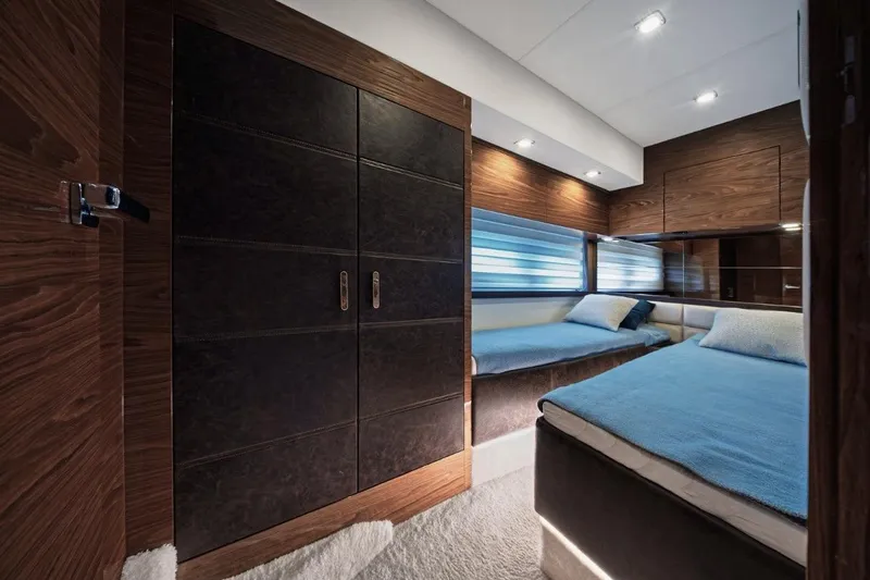  Yacht Photos Pics Luxurious interior of 2025 Cobrey 50 FLY yacht with twin beds and modern wood finishes.