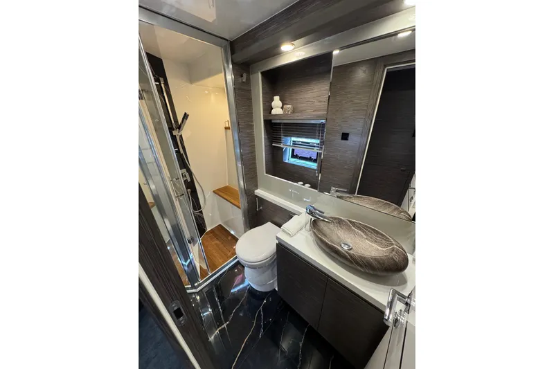  Yacht Photos Pics Luxurious bathroom in 2025 Cobrey 50 FLY yacht with modern fixtures and elegant design.