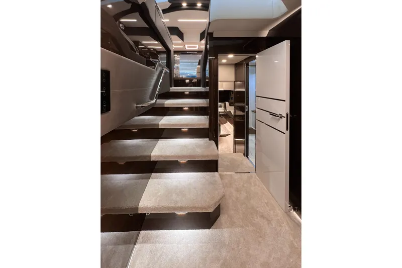  Yacht Photos Pics Luxurious interior of 2025 Cobrey 50 FLY yacht with modern staircase and ambient lighting.