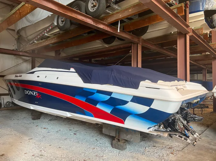 Flying Lady Yacht Photos Pics 2001 Donzi 38 ZX speedboat in storage, featuring a vibrant blue and red design.