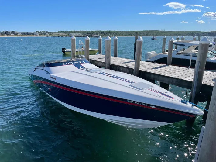 Flying Lady Yacht Photos Pics 2001 Donzi 38 ZX speedboat docked on clear blue water under a sunny sky.