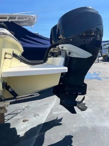  Yacht Photos Pics 2006 Jupiter 31 Center Console boat with powerful outboard motor in a sunny marina.